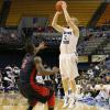 Lucas Eitel fires a three pointer over Robert Morris's Velton Jones.