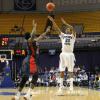 Steve McWhorter shoots a three pointer over Brandon Herman.