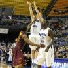 Lucas Eitel fires a three pointer over a Manny Arop screen.