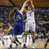 Shannon Thomas puts up a shot against strong Rachael Hackbarth defense.