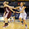 Andrea Rademacher hustles for a Brittany Schoen rebound.  Brittany,
grimacing on the floor, twisted her ankle.