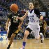 Anna Munn and WSU's Alex Harden race for a loose ball.