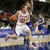 Carley Hall drives the paint against Rachael Hackbarth.