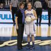 Coach Moren presents the 1,000 point club ball to Taylor Whitley.